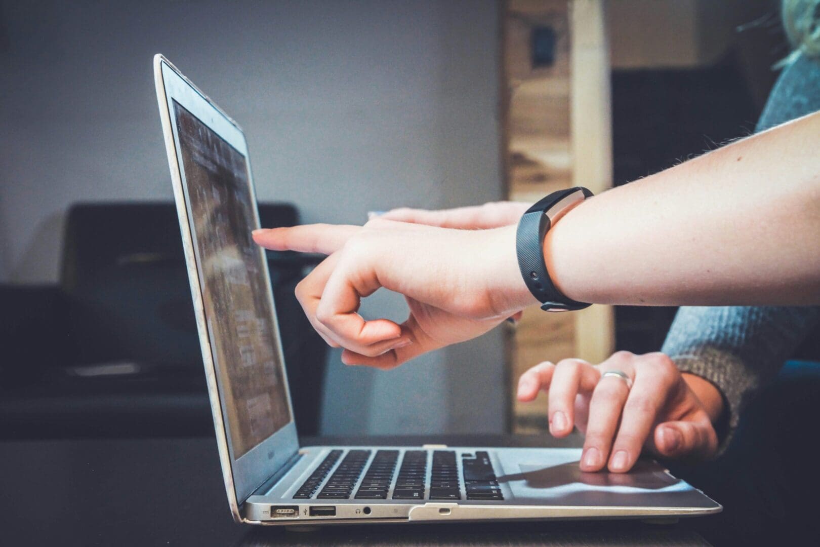 A person using their laptop on the table